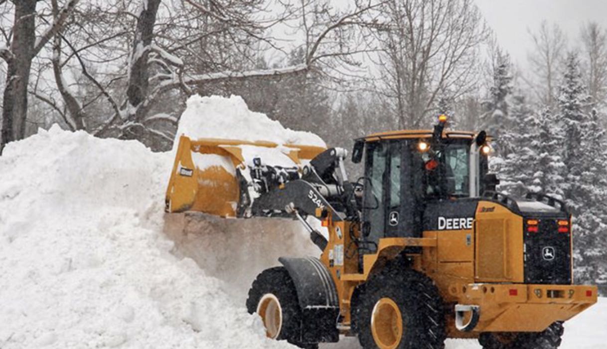 Land & Snow Services loader clearing a massive snow pile in Buffalo NY