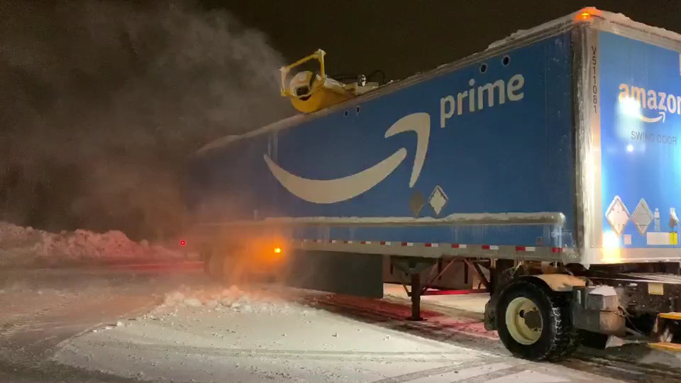 Trailer lot being cleared of snow overnight